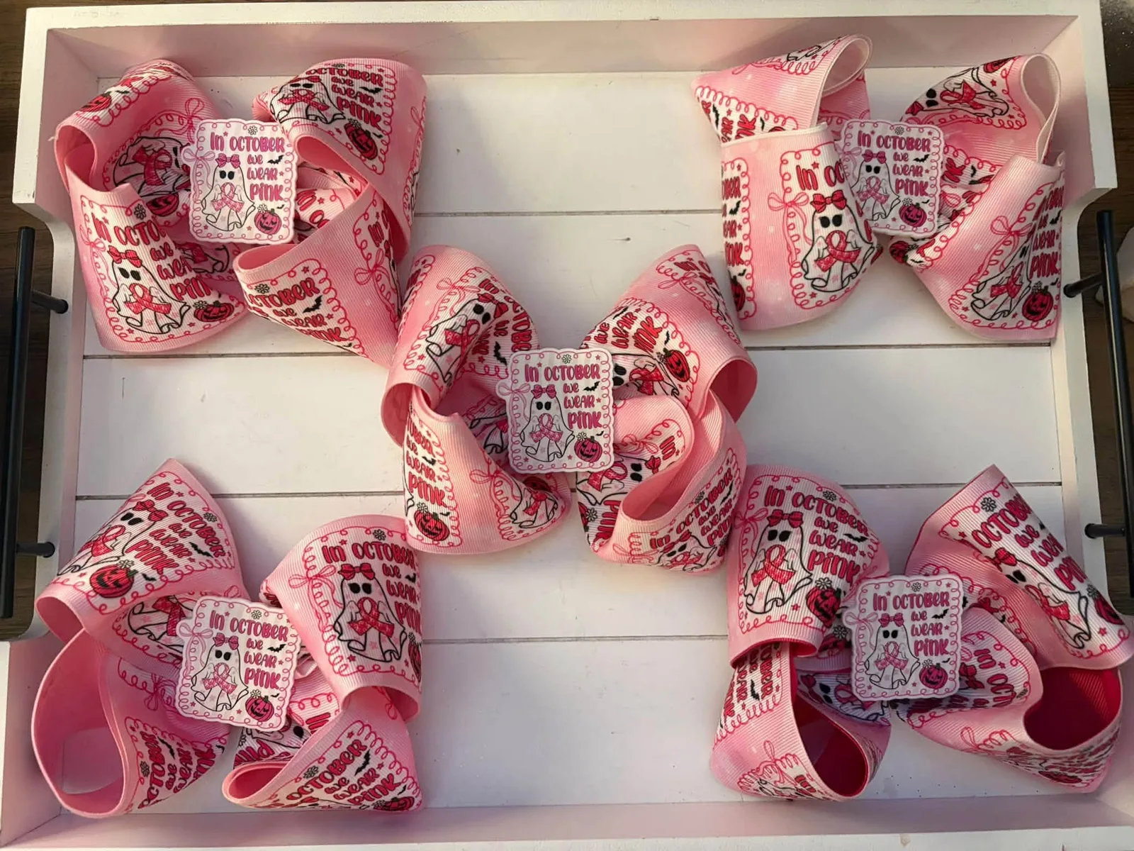A board of handmade In October We Wear Pink bows